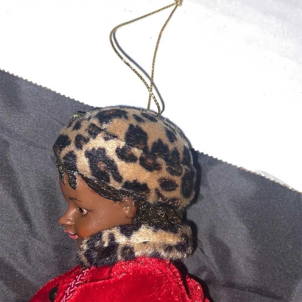 Vintage African American doll ornament with red velvet and leopard fur purse